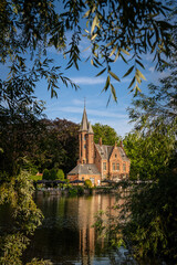 Obraz premium Framed View of Kasteel Minnewater Reflected on the Lake in Minnewater Park, Bruges, Belgium