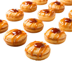 Assortment of mini donuts with caramel drizzle on black background small pastry