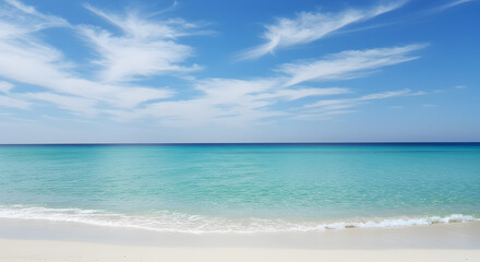 Obraz premium Turquoise Sea Water and White Sand Beach Under Blue Sky with Wispy Clouds in Summer