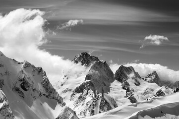 Winter mountains with snow cornice and sky with clouds in nice sun day
