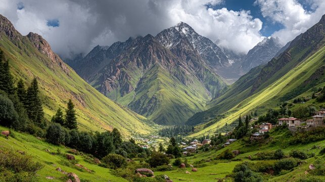 Lush green valley nestled between towering snow-capped mountains under a dramatic sky; small village visible - Powered by Adobe