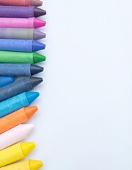 Colorful crayons lined up against a white background