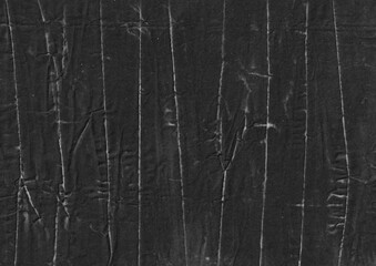 Black and white grunge paper background with creases. Distressed abstract backdrop for overlay. Crumpled surface graphic element.