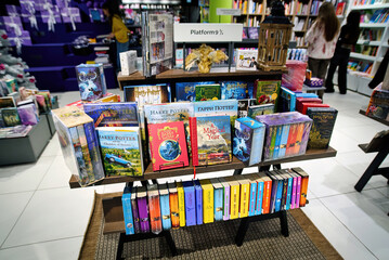 Fototapeta premium Minsk, Belarus. Jan 12, 2025. Decorative book stand with platform 9 3/4 inscription inspired by Harry Potter adventures displayed in bookstore, fantasy literature theme and magical storytelling