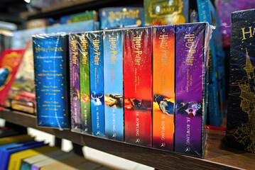 Naklejka premium Minsk, Belarus. Jan 12, 2025. Collection of Harry Potter novels in english language written by J.K. Rowling displayed on bookstore shelf, popular fantasy literature series. Selective focus