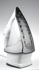 Modern white electric iron, angled view
