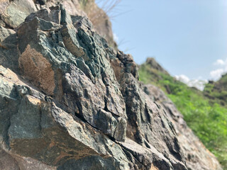 Rocky stone walls and dramatic peaks rise against the sky, creating a breathtaking mountain landscape