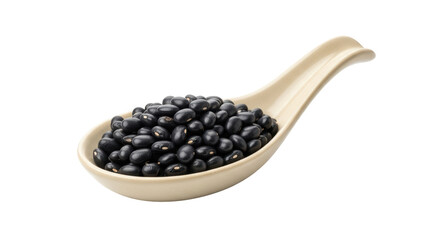 Isolated spoonful of shiny black beans, nutritious and edible dry legumes on an ivory spoon