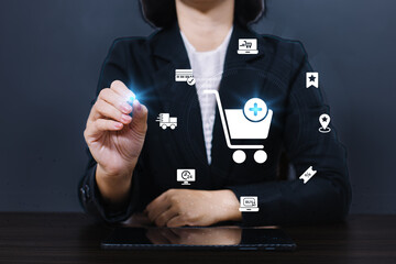 Businesswoman use computer touching with virtual shopping trolley cart and e-commerce icons such as credit cart, delivery truck ,sale percentage for online shopping concept.