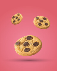 Three Chocolate Chip Cookies placed on a green background.