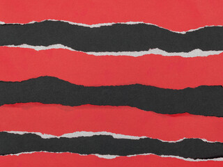 Strips of torn red paper on a black background.