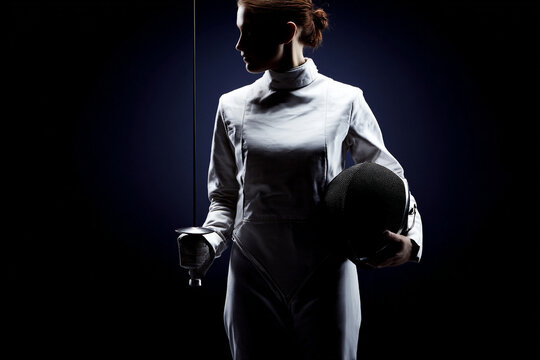 Silhouetted female athlete in fencing uniform, holding a foil and helmet under moody lighting