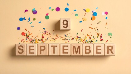 Fototapeta premium Wooden Blocks with Date 9 September. Calendar for birthday or anniversary on solid colored background with confetti