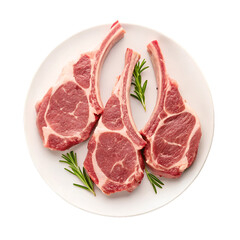 Three raw lamb chops with rosemary on a white plate isolated on black meat food