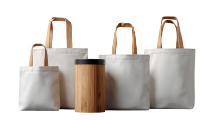 Several blank, off-white canvas tote bags of varying sizes are displayed. A light-brown bamboo tumbler sits between them