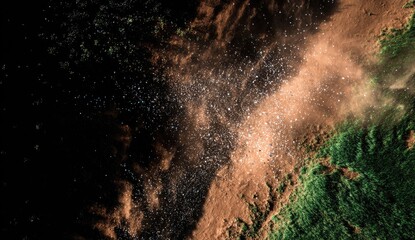 Aerial view of dirt and debris erupting from a path, over dark green vegetation