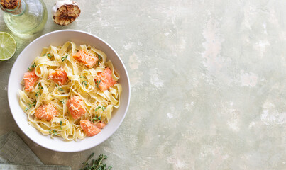 Pasta fettuccine in a creamy sauce with salmon, cheese and thyme. Italian cuisine. Healthy eating.