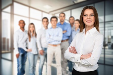 Successful Businesswoman Standing with Business Team In Modern Office