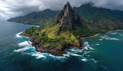 Dramatic aerial view of a lush, rocky Hawaiian coastline with a dramatic peak