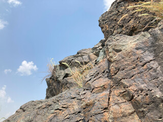 striking visual of weathered rocks ascends towards a brilliant blue sky, a testament to nature's grandeur and the enduring power of stone.