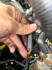Crankshaft Sensor Connector Held by Car Mechanic During Engine Repair