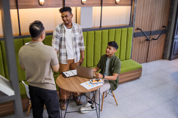 Asian Man in Modern Office Space, Shaking Hands With Two Young Entrepreneurs