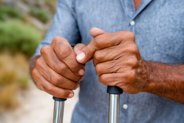 Close Up Of Senior Hands Holding Walking Poles