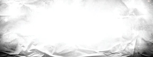 Abstract grayscale image of crumpled, textured surface with a bright center