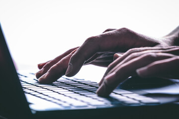 Hands typing on the computer keyboard. Modern style