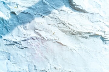 Crumpled, light-blue paper texture with shadows