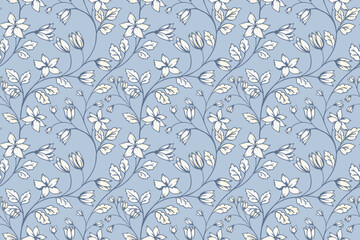 Seamless vector pattern with delicate cream flowers and leaves on a soft blue background. Elegant botanical design for fabric, wallpaper, stationery, and wrapping © incarnadine