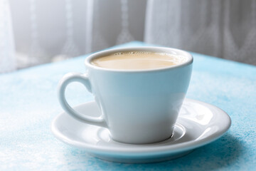  Large White Cup of Milky Coffee on a Blue Background