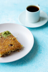 Close-Up of local Turkish Kadaif Dessert and Turkish Coffee on a Pink Plate
