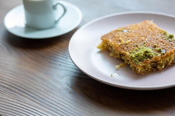 Close-Up of local Turkish Kadaif Dessert and Turkish Coffee on a Pink Plate
