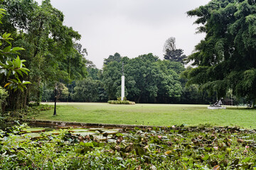 Elegant statue in the heart of the vast lawns of the Bogor Botanical Garden