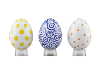 Three porcelain Easter eggs (yellow polka dots, blue swirls, orange confetti) on acrylic stands, isolated on transparent background, high-angle commercial product display