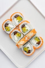 Philadelphia salmon sushi roll with ingredients isolated on white background