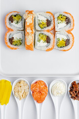 Philadelphia salmon sushi roll with ingredients isolated on white background