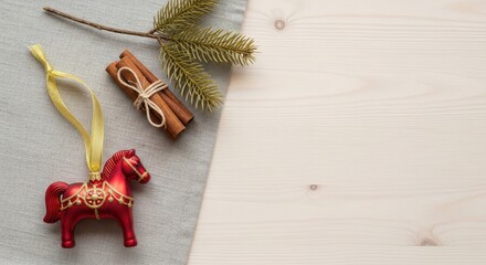 Red horse ornament with cinnamon and evergreen on winter wood background for New Year 2026  