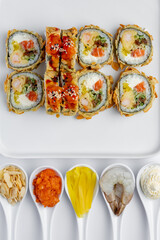 Baked sushi roll with salmon close-up on a white background isolated