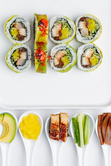 Sushi roll with eel, crab and caviar on a white background isolated