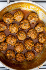 Close-Up of Spanish Albóndigas in Tomato Sauce Cooked in a Skillet
