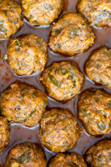 Close-Up of Spanish Albóndigas in Tomato Sauce on a White Plate
