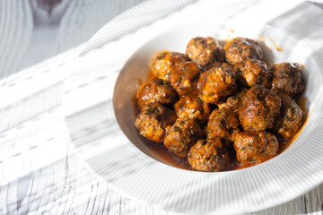 Close-Up of Spanish Albóndigas in Tomato Sauce on a White Plate
