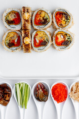 Sushi roll with eel, crab and caviar on a white background isolated