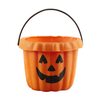 Orange plastic Jack-o'-lantern bucket for Halloween candy isolated on black