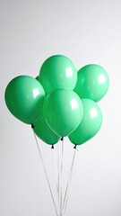 A Bunch of Vibrant Green Balloons Floating Against a Clean White Background