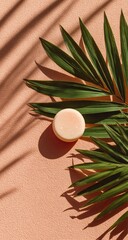 Light peach-toned background with palm leaf and round, light pink solid soap