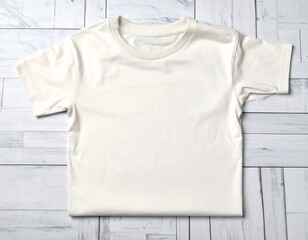 Blank cream-colored t-shirt on light wood