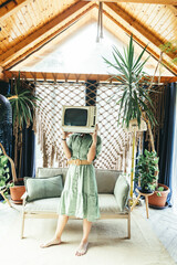 woman holding retro tv set